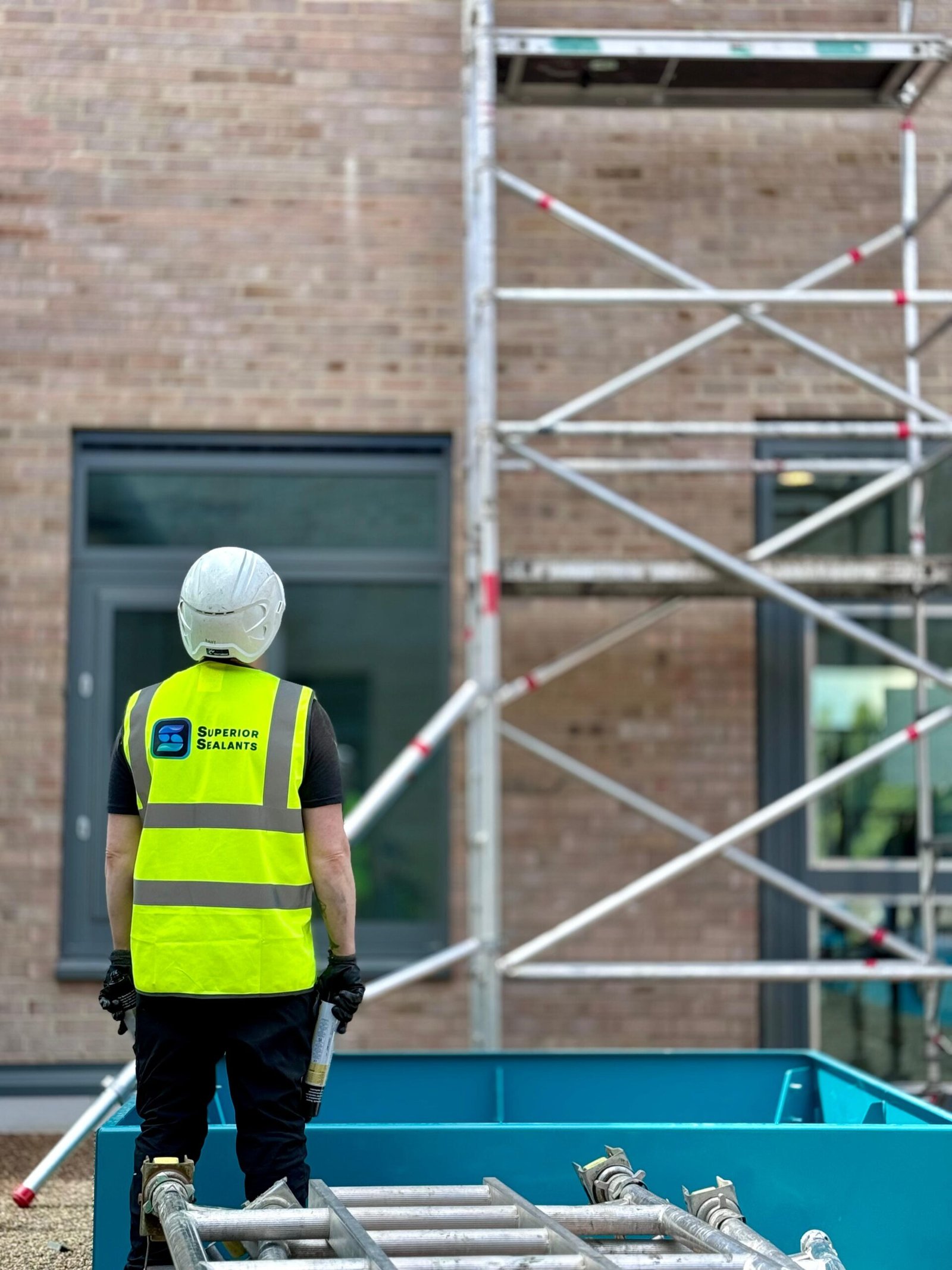 Superior Sealants operative on site beside scaffolding